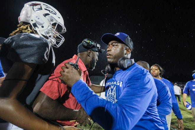 Pahokee head coach Emmanuel Hendrix shakes hands with Palm Beach Central head coach Kevin Thompson after the end of the football game between Pahokee and host Palm Beach Central on Friday, September 16, 2022 in Wellington, FL.  Final Score, Pahokee, 34, Palm Beach Central, 14.