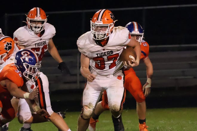 Byron's Caden Considine charges for some of his 145 yards during the Tigers' 35-15 win over Genoa-Kingston in Genoa on Friday, Sept. 16, 2022.