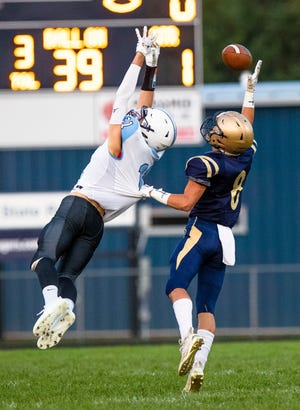 New Prairie's Brice VanBruaene (8) gets called for pass interference on Saint Joseph's Dom Cremers (21) during the New Prairie vs. Saint Joseph High School football game Friday, Sept. 16, 2022 at New Prairie High School in New Carlisle.