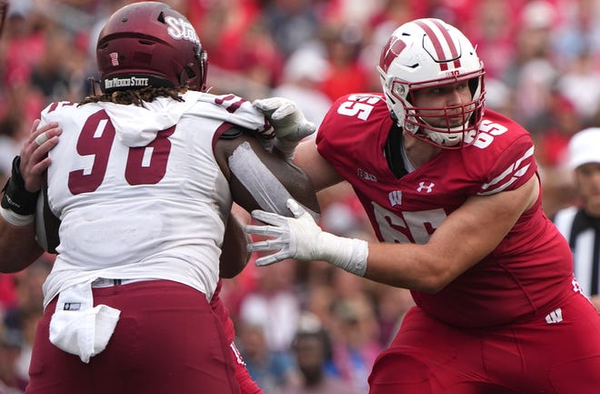 Wisconsin offensive lineman Tyler Beach blocks New Mexico State defensive lineman Izaiah Reed during their game Sept. 17. Beach moved from left tackle to left guard this season and he started the first five games, but an ankle injury altered the direction of his season.