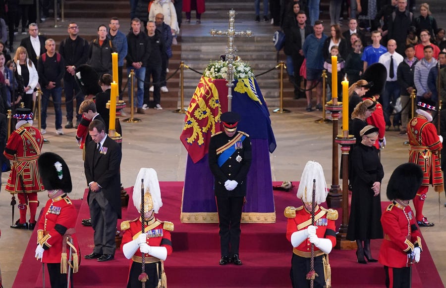 Queen Elizabeth II's grandchildren hold a vigil around her coffin, lying in state on the catafalque in Westminster Hall in London ahead of her funeral on Monday.
