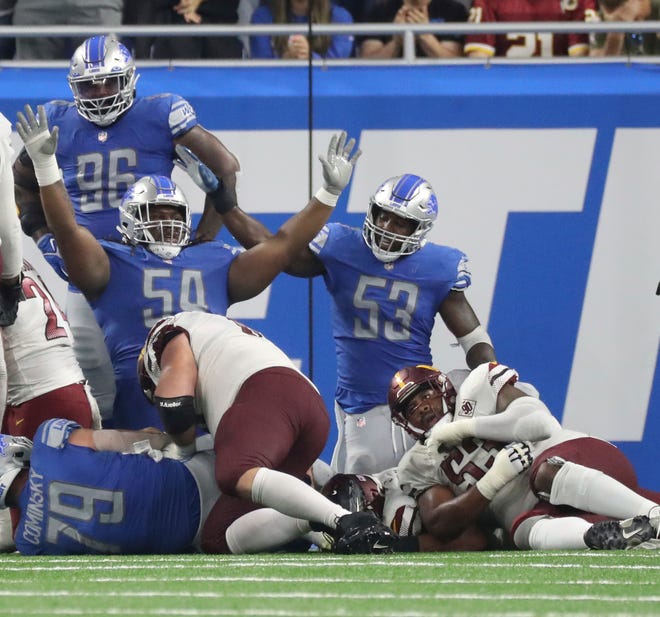Detroit Lions defensive tackle Alim McNeill (54) and linebacker Charles Harris (53) celebrate a stop at the goal line against the Washington Commanders during the second half at Ford Field, Sept. 18, 2022.