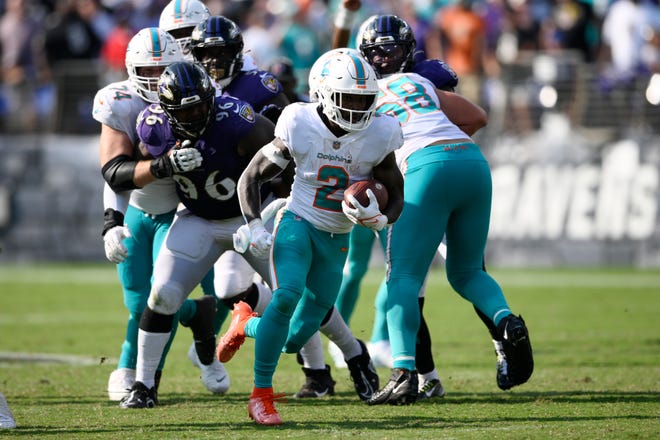 Miami Dolphins running back Chase Edmonds (2) runs the ball during the second half of an NFL football game against the Baltimore Ravens, Sunday, Sept. 18, 2022, in Baltimore.