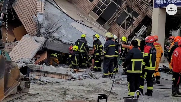 Rescue workers search through a crumbled structure