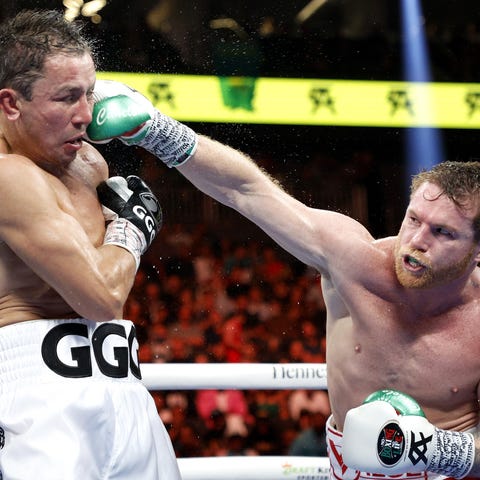 Canelo Alvarez lands a punch against Gennady Golov