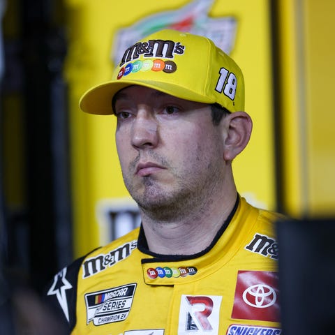 Kyle Busch speaks with the media after a mechanica