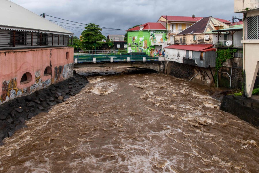 This photograph taken on Sept. 17, 2022, shows water rushing under a bridge in Basse-Terre on the French island of Guadeloupe, after the passage of Tropical Storm Fiona.
