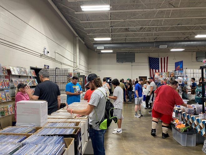 Comic book fans gather to explore merchandise provided by dozens of vendors at the Comic Book Fest in Columbia Saturday.