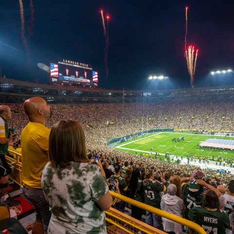 Fans stand for the National anthem before the Gree