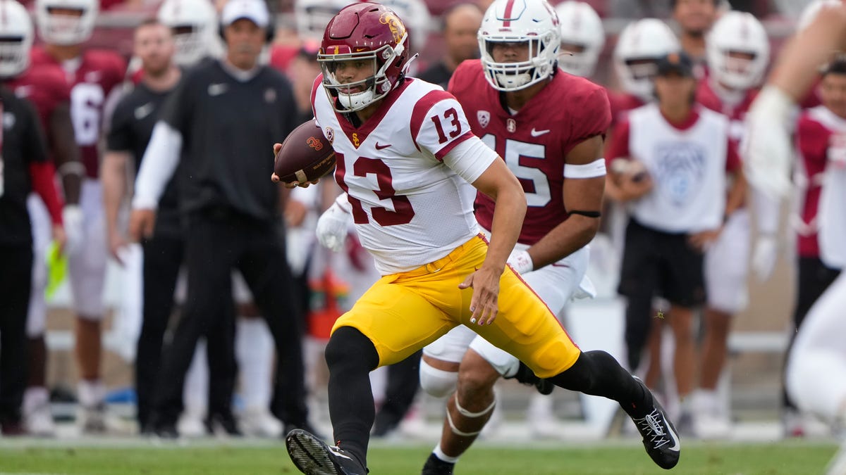 Southern California quarterback Caleb Williams (13) runs with the football against Stanford during the first quarter at Stanford Stadium.