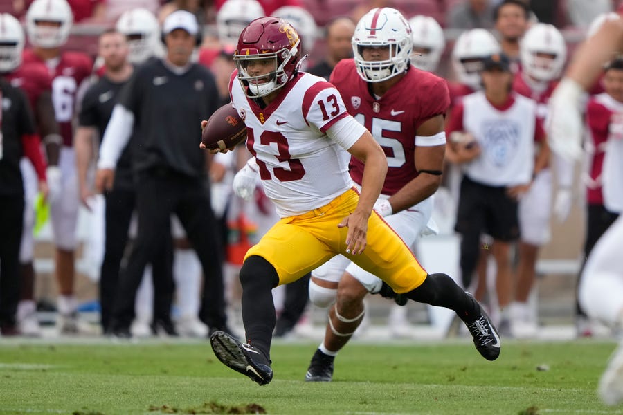 Southern California quarterback Caleb Williams (13) runs with the football against Stanford during the first quarter at Stanford Stadium.