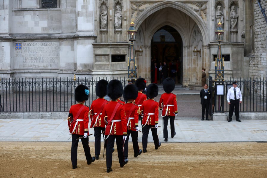 Soldiers in ceremonial uniform walk into Westminster Abbey, on the day of the Queen Elizabeth II funeral, at Westminster Abbey in London Monday, Sept. 19, 2022.