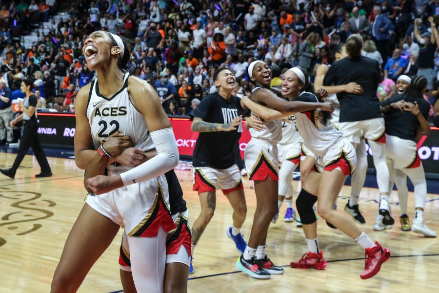 The Las Vegas Aces celebrate after winning the 2022 WNBA Championship with a victory over the Connecticut Sun in Game 4 of the Finals.
