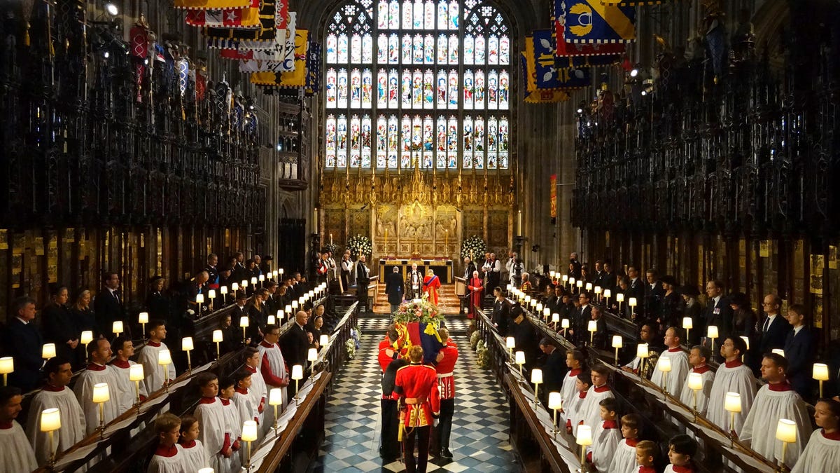 The coffin of Queen Elizabeth II is carried into St George's Chapel for her Committal Service, in Windsor Castle, Monday Sept. 19, 2022. (Jonathan Brady/Pool Photo via AP) ORG XMIT: MEM145
