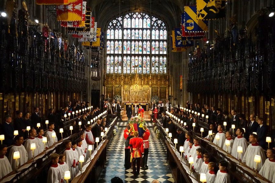 The coffin of Queen Elizabeth II is carried into St George's Chapel for her Committal Service, in Windsor Castle, Monday Sept. 19, 2022.
