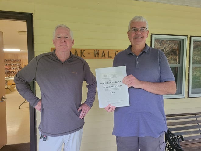 Geneseo Ikes' President, Brian Herron. left, recently awarded Doug Brock the Tobin Award for all his excellent volunteer work for the Geneseo Izaak Walton League.
