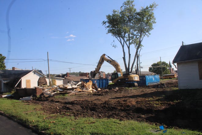 Crews are demolishing structures to make way for a parking lot on Sept. 20, 2022.