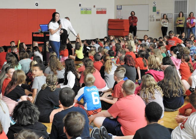 Intervention Specialist Jamie Swigert speaks at a pep rally Tuesday at Coshocton Elementary School focused on the REAL Redskin initiative. The acronym stands for respectful, elevate others, accountable and leader. It was the first mass school gathering held in about two years because of the COVID-19 pandemic.
