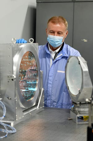 Anatoly Maksimchuk, research scientist, stands with some adaptive optics, which are used for wave front corrections.  Photographed on Monday, Sept.  19, 2022 at the Gerstacker Building in Ann Arbor.