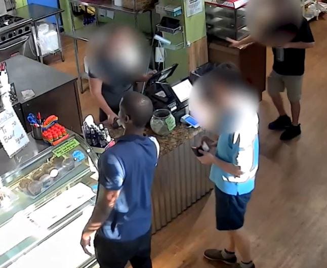 This screen grab, courtesy of the Lee County Sheriff's Office, shows the seconds immediately prior to a man, left, grabbing a pair of scissors and stabbing the man next to him on Monday, September 19, 2022, at The Trading Post at Burnt Store Marina in Punta Gorda. The victim was stabbed more than 40 times and deputies arrested Edmond Clarke III, 36, on site.