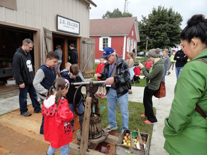 A honey and apple press is demonstrated at The New Berlin Historical Society's Applefest.