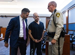 Outgoing Clark County Public Administrator Robert Telles, center, leaves the courtroom with David Lopez-Negrete, a public defender, left, after his arraignment at the Regional Justice Center, on Tuesday, Sept. 20, 2022, in Las Vegas.