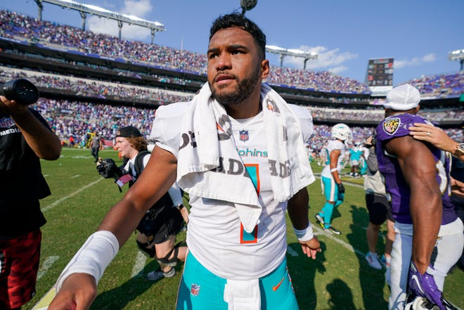Miami Dolphins quarterback Tua Tagovailoa walks on the field after an NFL football game against the Baltimore Ravens, Sunday, Sept. 18, 2022, in Baltimore. (AP Photo/Julio Cortez)