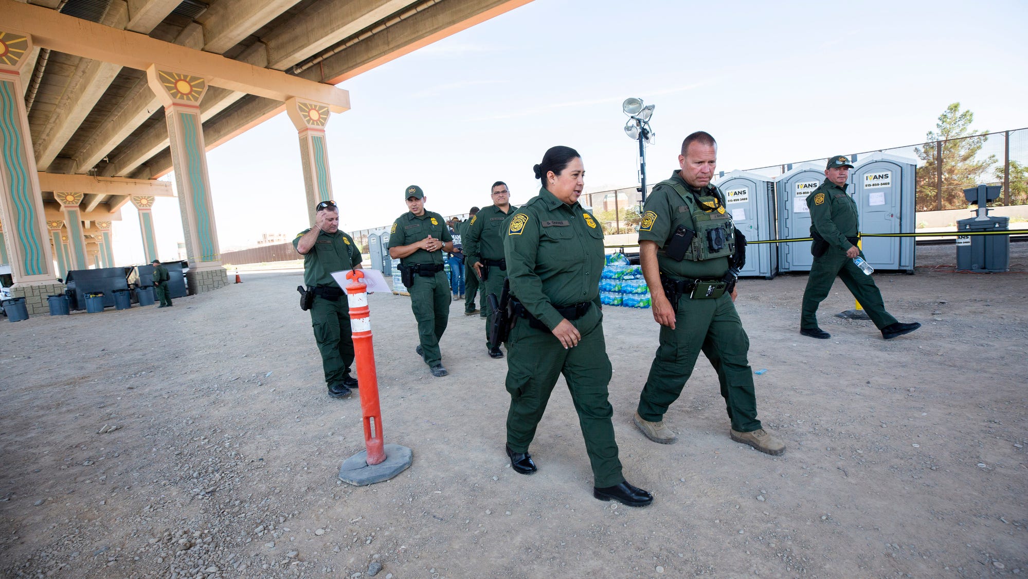 El Paso Sector U.S. Border Patrol Chief Gloria I. Chavez, third from right, visits an area where migrants are being processed just north of the Rio Grande in El Paso, Texas, on Tuesday.
