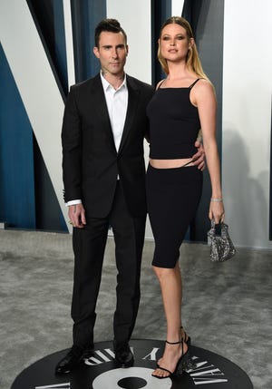 Adam Levine, left, and Behati Prinsloo arrive at the Vanity Fair Oscar Party on Sunday, Feb. 9, 2020, in Beverly Hills, Calif. (Photo by Evan Agostini/Invision/AP) ORG XMIT: CAAS664