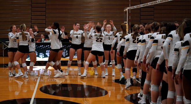 The Adrian College women's volleyball lines up prior to the start of Tuesday's MIAA match against Trine.