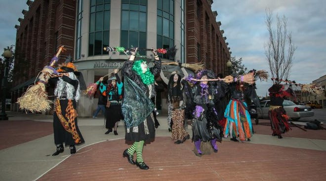 Members of the Lake Eerie Hexenbrut Dance Group perform in front of Monroe Bank and Trust’s Headquarters on Front St. in 2019.