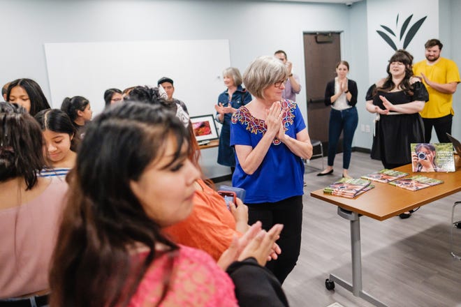 Sherrell Rieger applauds at the opening night of the Adelante Arts Camp Tuesday at the Tuscalawas County Public Library in New Philadelphia.