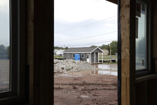 A model tiny home is shown amid construction Sept. 20 at the Oshkosh Kids Foundation's Tiny Homes Village on the 200 block of W. Packer Ave. The village is scheduled to start housing families in January.