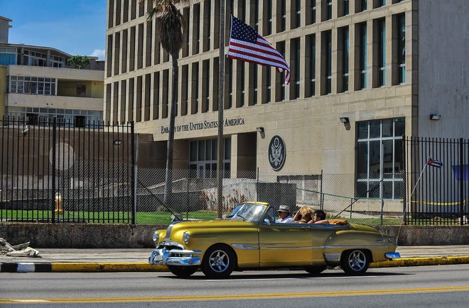 A car drives by the US embassy in Havana, Cuba on October 3, 2017.  AFP PHOTO / YAMIL LAGEYAMIL LAGE/AFP/Getty Images