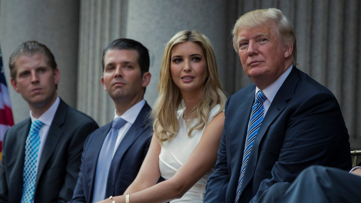 Donald Trump, right, sits with his children, from left, Eric Trump, Donald Trump Jr., and Ivanka Trump on July 23, 2014. New York's attorney general sued former President Donald Trump and his company on Wednesday, Sept. 21, 2022, alleging business fraud involving some of their most prized assets, including properties in Manhattan, Chicago and Washington, D.C.