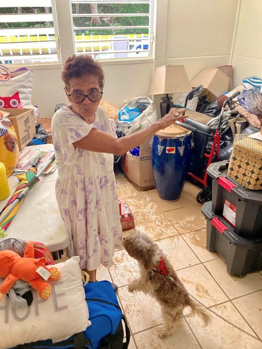 Maria de Jesus Medina, 83, stands in her home in the Ariel neighborhood of Comerío, Puerto Rico, on Sept. 21, 2022. Her apartment was flooded when rains from Hurricane Fiona caused the river and creek in her neighborhood to flash flood.