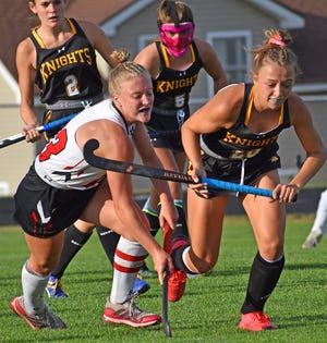 Honesdale's Claire Campen (23) slashes  her way through a host of Lake Lehman defenders while attacking the cage this week in Wyoming Valley Conference field hockey action.