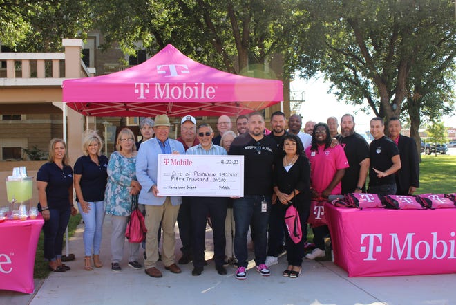 T-Mobile employees present a $50,000 check to City of Plainview officials Thursday. The city plans to use the grant to install a speaker system along a downtown corridor.