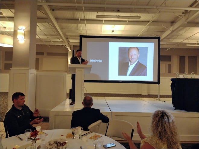 Nick Florian, board chairman of the Otsego County Economic Alliance (OCEA), led a tribute to the late Mike Perdue at the organization's partner celebration on Sept. 21. Perdue, a former OCEA board member, died along with three others in a plane crash on Beaver Island last Nov. 13.
