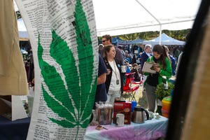 Jodi James, center, of the Florida Cannabis Action Network speaks to a festival goer signing a petition during HempFest, a celebration of hemp and a protest for marijuana legalization, at Bo Diddley Plaza in downtown Gainesville in 2011.