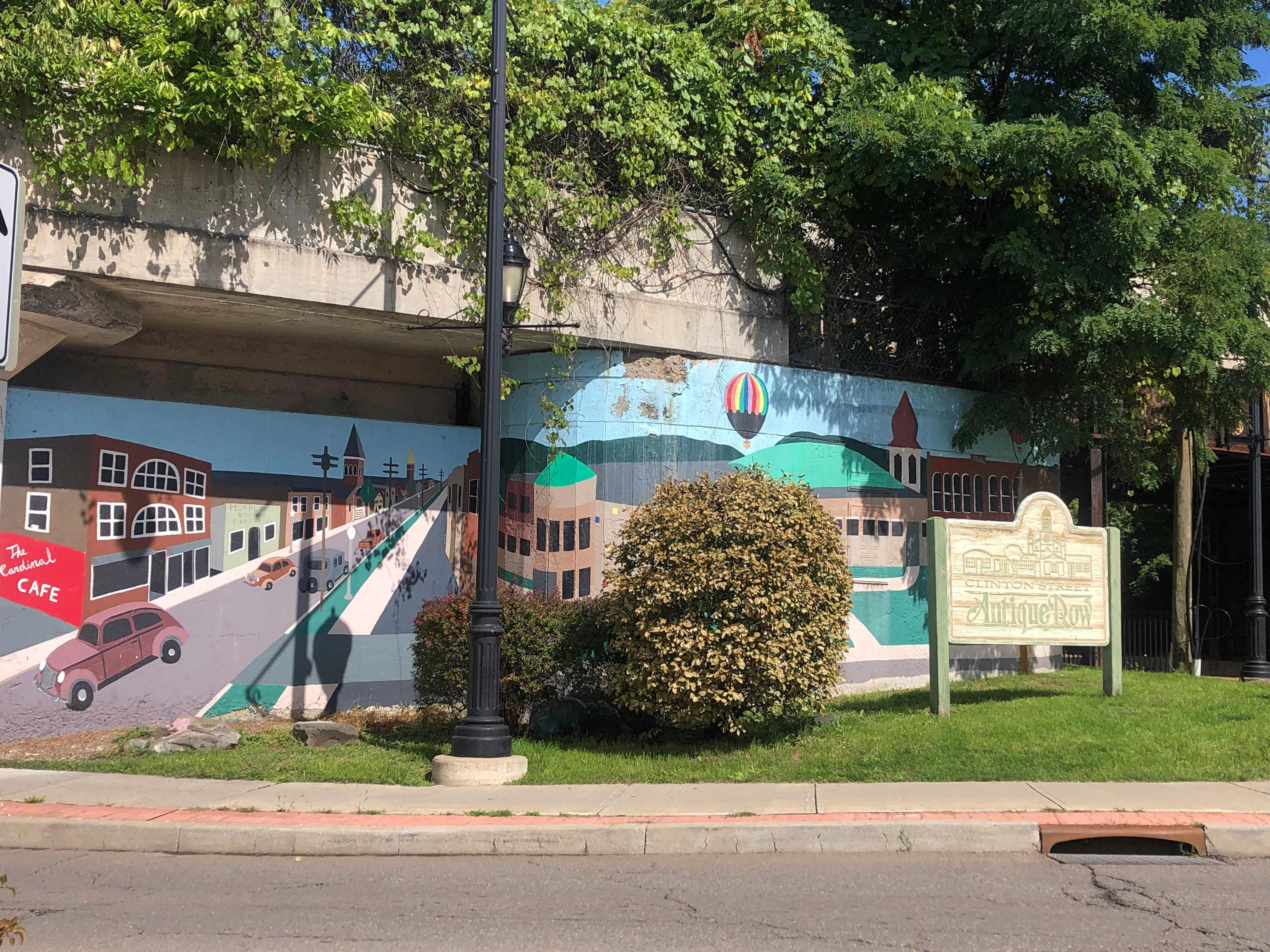 At the intersection of E. Clinton Street and Front Street, a mural depicting familiar buildings and hot air balloons welcomes people to the Clinton Street Antique Row.