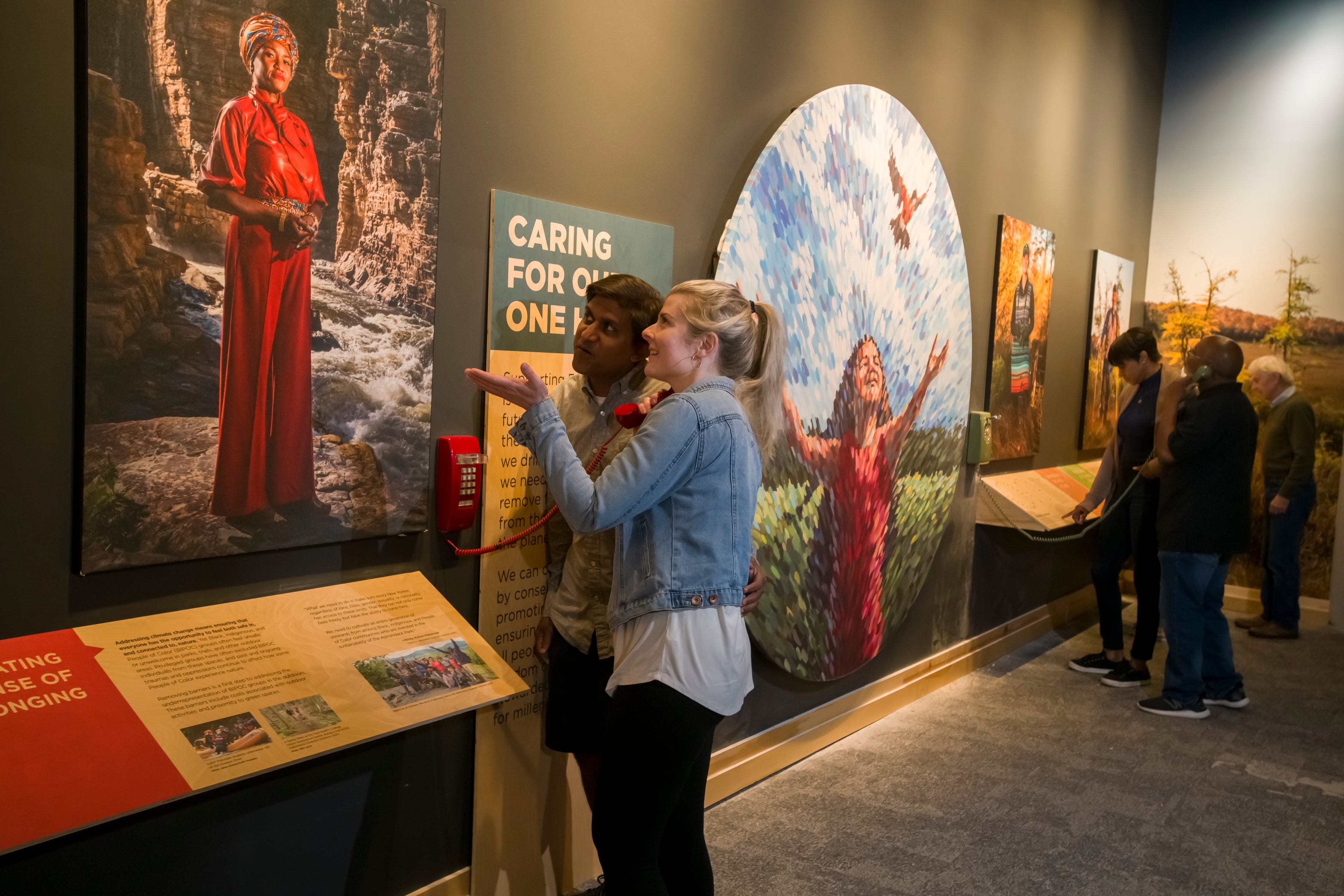 Visitors explore a new exhibit at The Wild Center in Tupper Lake, New York, showcasing New Yorkers working to tackle climate change.