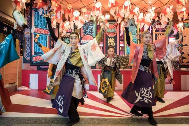 Dancers perform during a preview of the Asakusa Yokocho alley on June 29, 2022 in Tokyo. The newly-built restaurant gathering facility opened in one of Tokyo's most famous tourist spots after Japan reopened its borders to tourist groups.