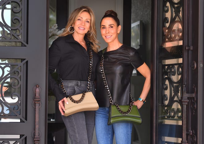 Charlotte Wienckoski (left) and Leigh Dorough, co-founders of Eslla, model two of their vegan handbags.