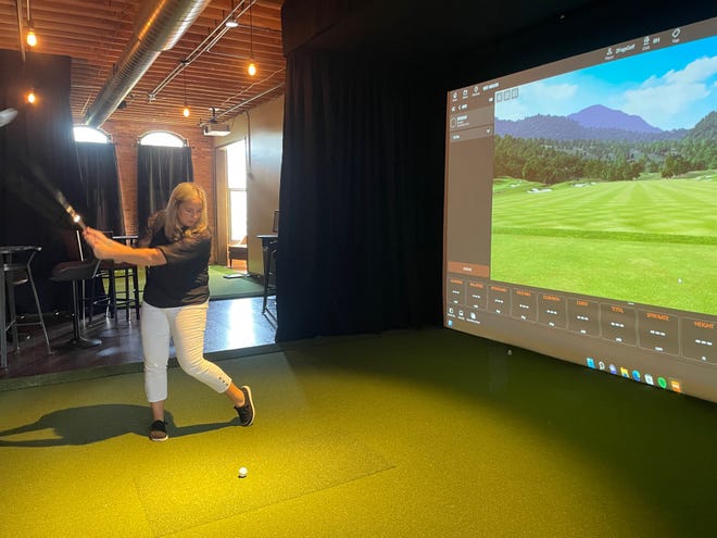 2FOG's Pub co-owner Holly Fletcher demonstrates a TrackMan golf simulator at the new 2FOG's Golf venue on the second floor above the pub, Monday, Sept. 19, 2022.