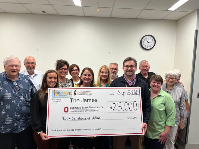Karis' Cause volunteers donate a $25,000 check to The James Cancer Hospital for virtual reality technology at a new proton therapy clinic scheduled to open next year.
(Photo: Submitted by The James Cancer Hospital)