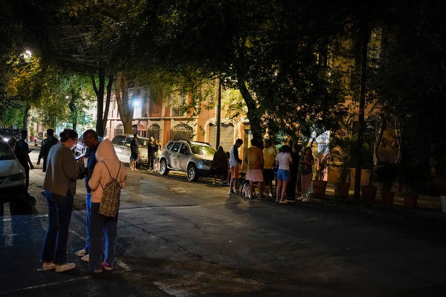 People gather outside after an earthquake was felt in Mexico City, Thursday, Sept. 22, 2022. The earthquake struck early Thursday, just three days after a deadly earthquake shook western and central Mexico.