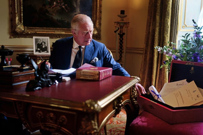 King Charles III carries out official government duties from his red box in the Eighteenth Century Room at Buckingham Palace, in a picture released by the palace on Sept. 23, 2022.