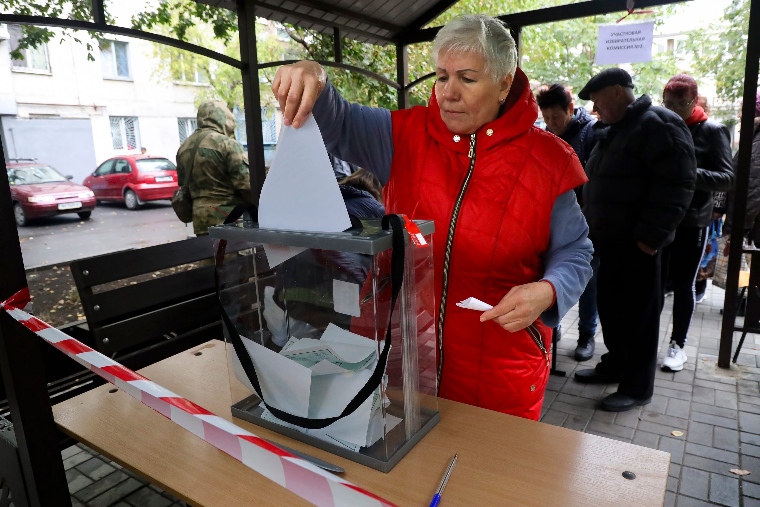 A woman votes during a referendum in a mobile polling station in Mariupol, Donetsk People's Republic, controlled by Russia-backed separatists, eastern Ukraine, Friday, Sept. 23, 2022. Voting began Friday in four Moscow-held regions of Ukraine on referendums to become part of Russia.