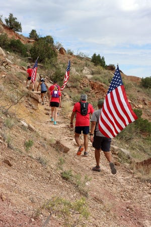 Teams of four to seven people carried American flags up and down the CCC Trail in Palo Duro Canyon as part of the annual Iwo Jima Flag Run Saturday, honoring those who survived and sacrificed at the battle of Iwo Jima during World War II.